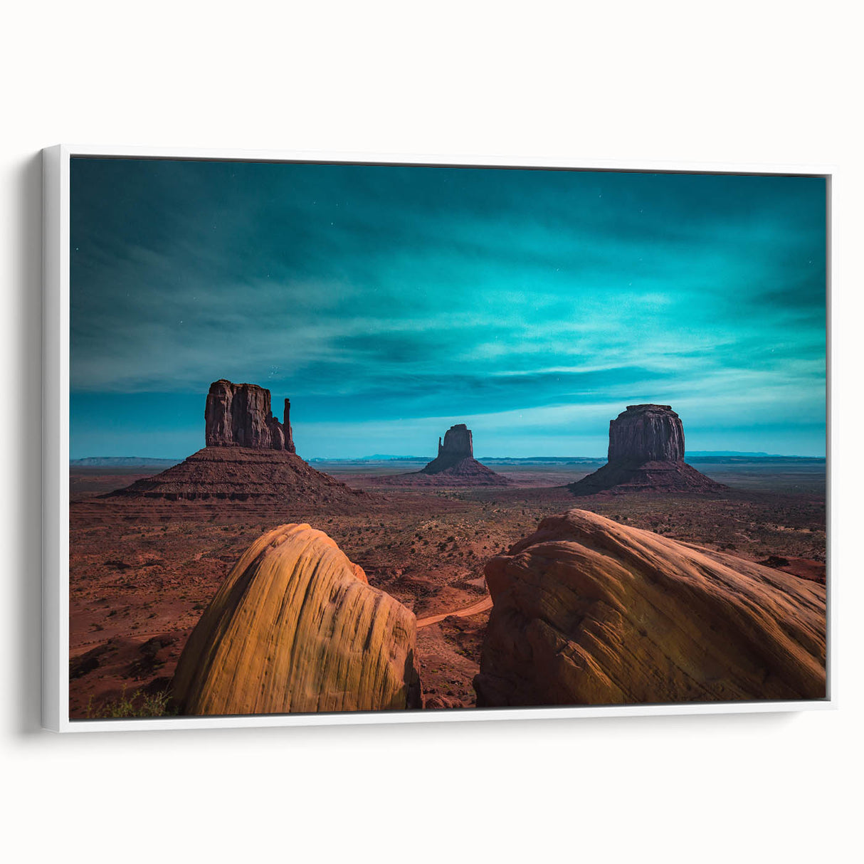 Vintage poster art of Monument Valley in vibrant orange and red tones on a large framed canvas.