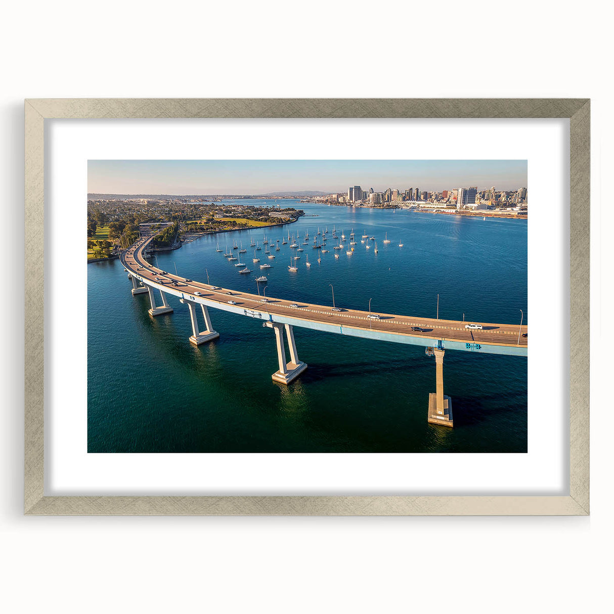 Textured abstract art print depicting Coronado, California in muted blue and green hues on a framed silver mat.
