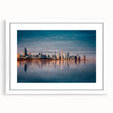 Abstract art print of Chicago skyline in muted gray and blue tones on a framed white mat, suitable for dining room decor.