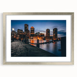 Textured art print of abstract Boston skyline in muted gray and blue tones, framed in silver, ideal for bedroom art.