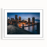 Abstract art print of Boston skyline in muted blue and gray tones on a framed white mat, ideal for dining room decor.