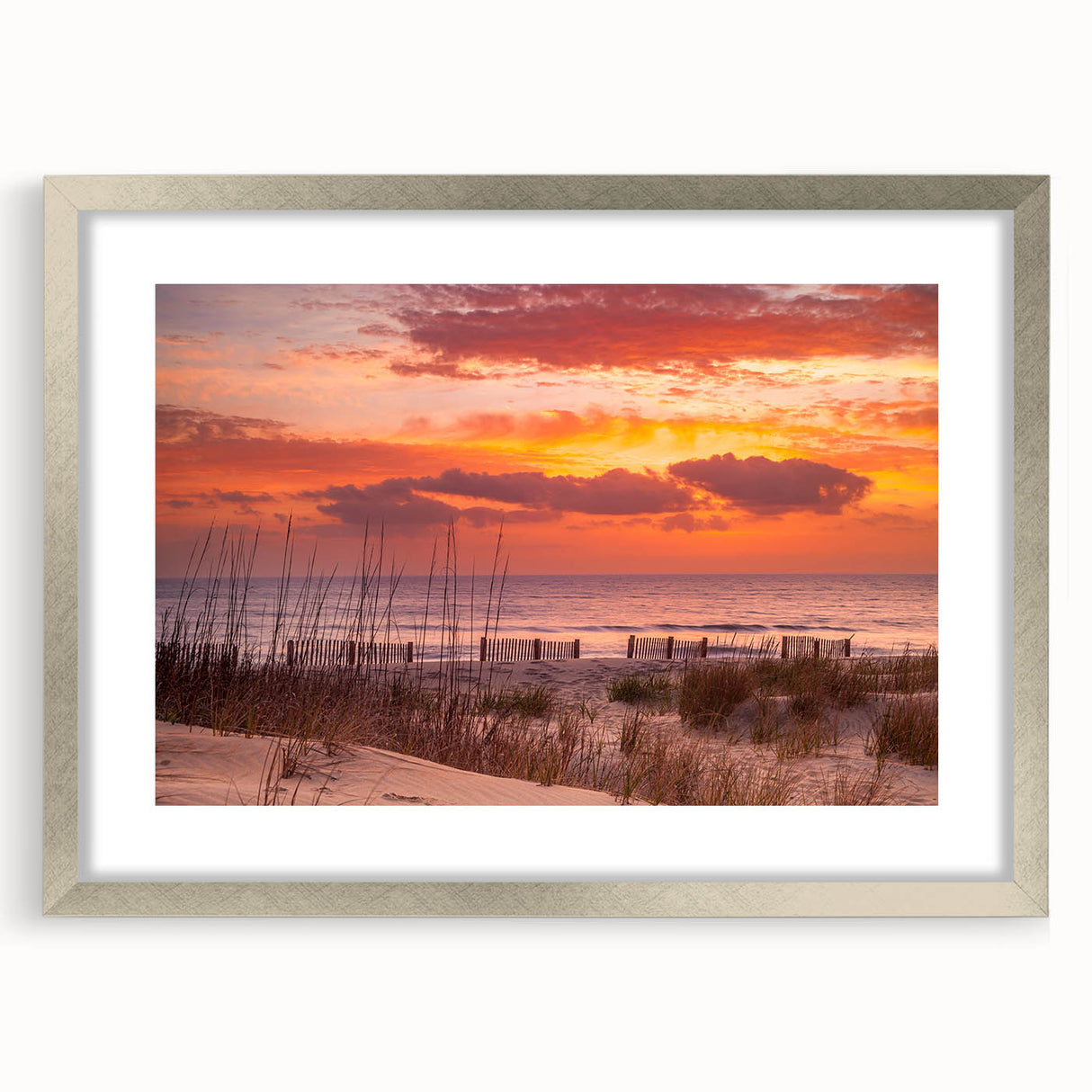 Textured art depicting the Outer Banks in abstract style with muted blue and gray tones on a framed silver mat.