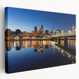 Side view of a large stretched canvas depicting the Portland, Oregon skyline in muted gray and green tones.