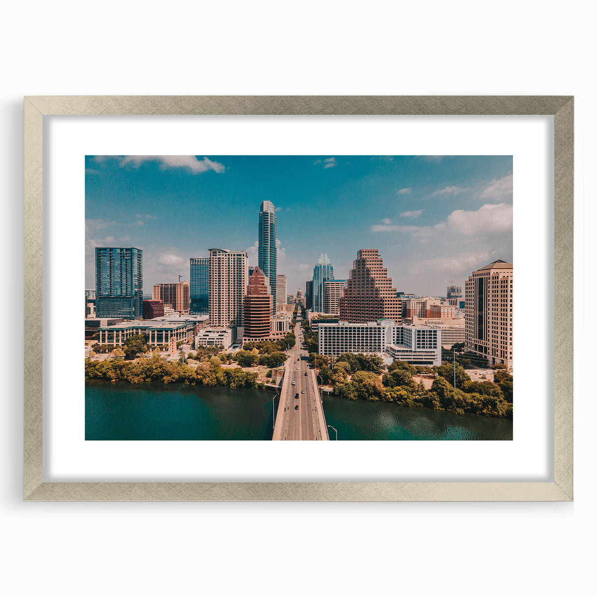 Textured abstract art print of Austin skyline in muted earth tones on a framed silver mat, suitable for bedroom decor.