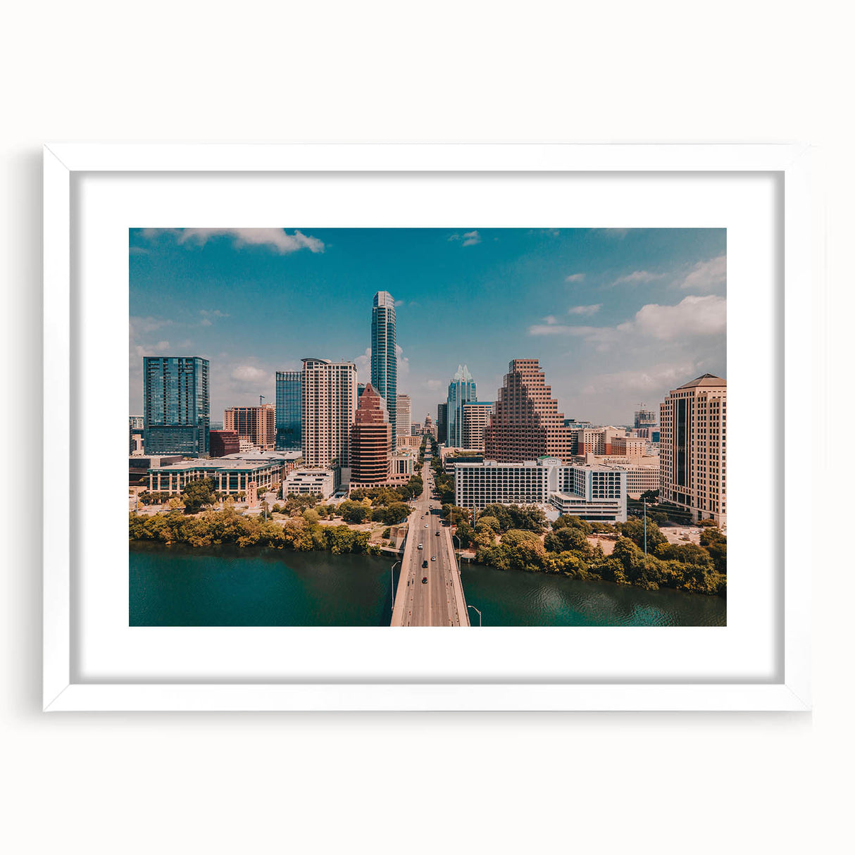 Abstract art print of Austin skyline in muted blue and gray tones, framed with a white mat.