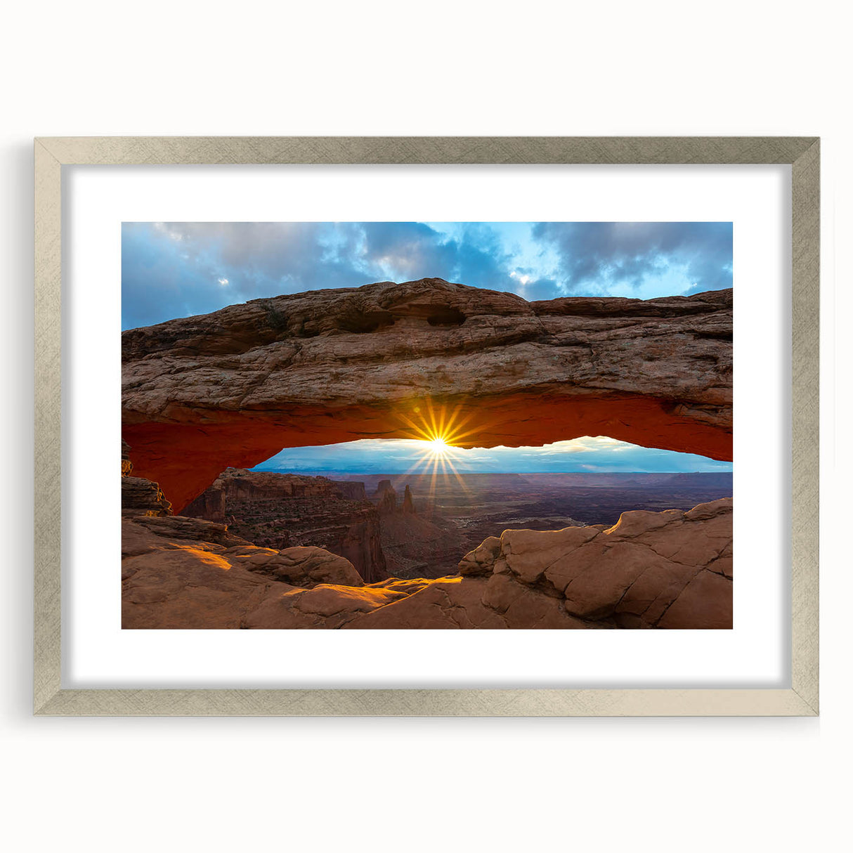 Textured art print of Arches National Park in muted earth tones on a framed silver mat, ideal for bedroom decor.