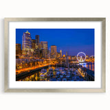 Textured art depicting an abstract Seattle skyline in muted gray and blue tones on a framed silver mat.