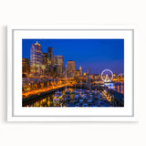 Abstract art print of Seattle skyline in muted gray and blue tones on a framed white mat, ideal for dining room decor.