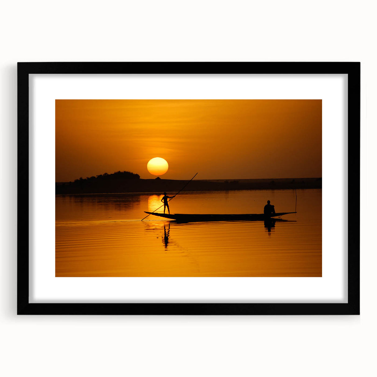 Abstract art print of African scenery in vibrant colors on a large textured canvas, framed in black.