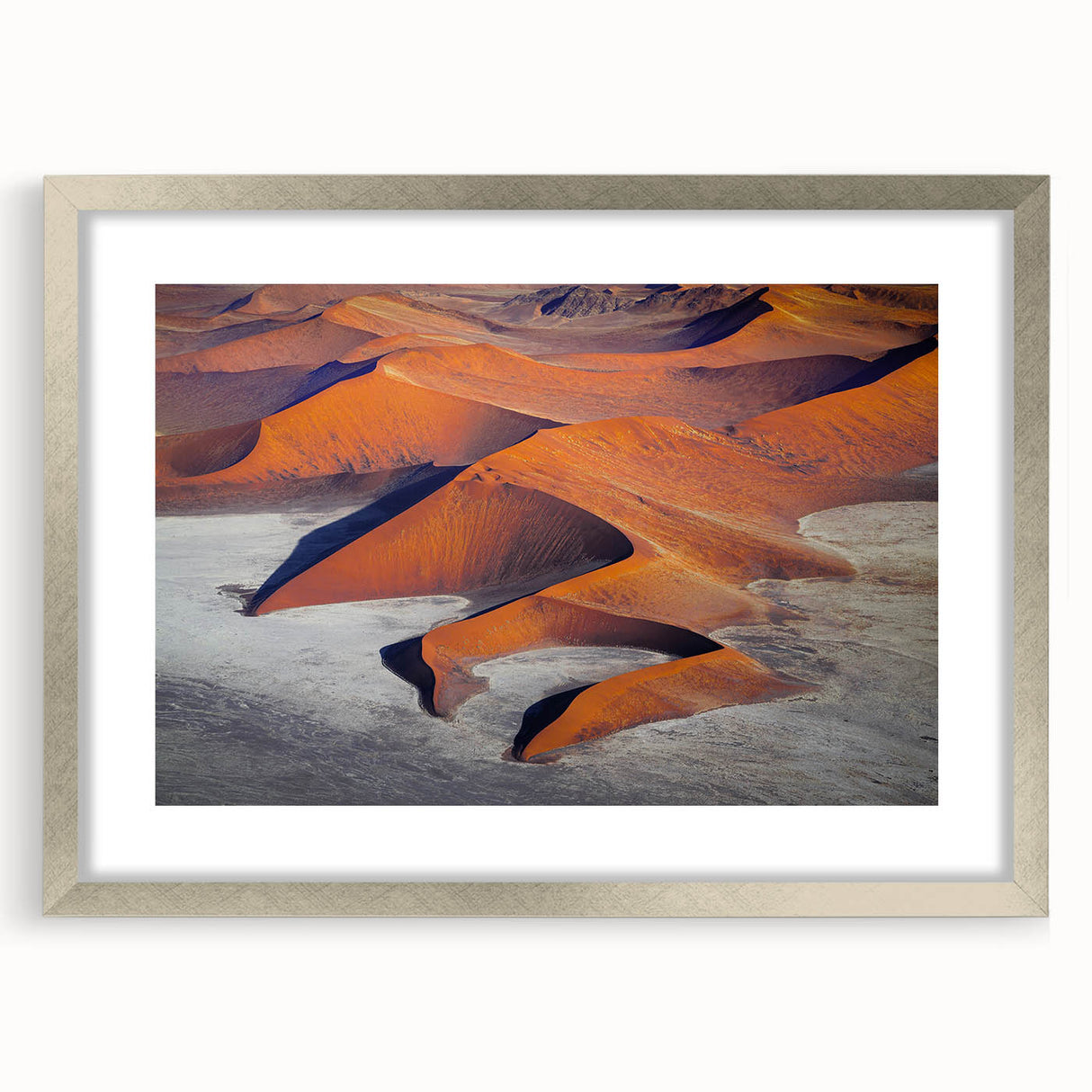 Abstract art print of a Namibian landscape in muted earth tones on a framed silver mat, ideal for dining room decor.