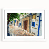 Abstract art print featuring a Tunisian landscape in muted earth tones on a framed white mat, suitable for dining room decor.