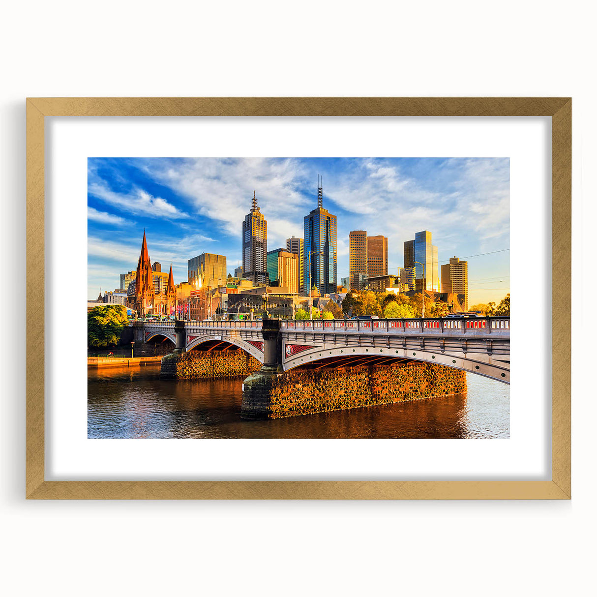 Textured abstract art print of Melbourne scenery in muted gold and blue tones, framed with a gold mat, ideal for bedroom art.
