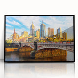 Large abstract wall art depicting Melbourne's skyline in muted gray and blue tones on black framed acrylic.
