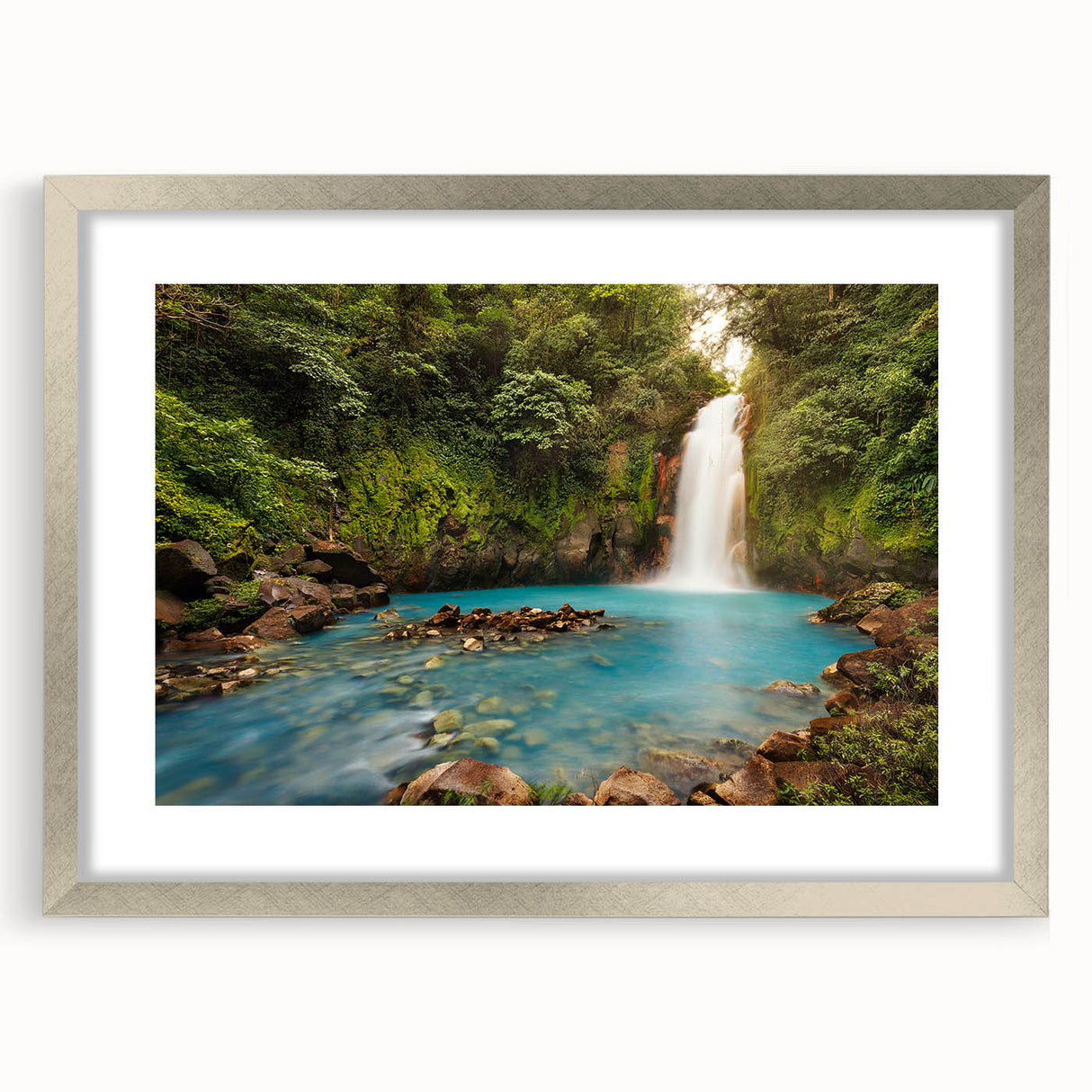 Textured abstract art print of a Central American landscape in muted earth tones, framed in silver, ideal for bedroom art.