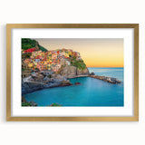 Abstract art print of Cinque Terre with vibrant coastal colors on a framed gold mat, ideal for dining room decor.