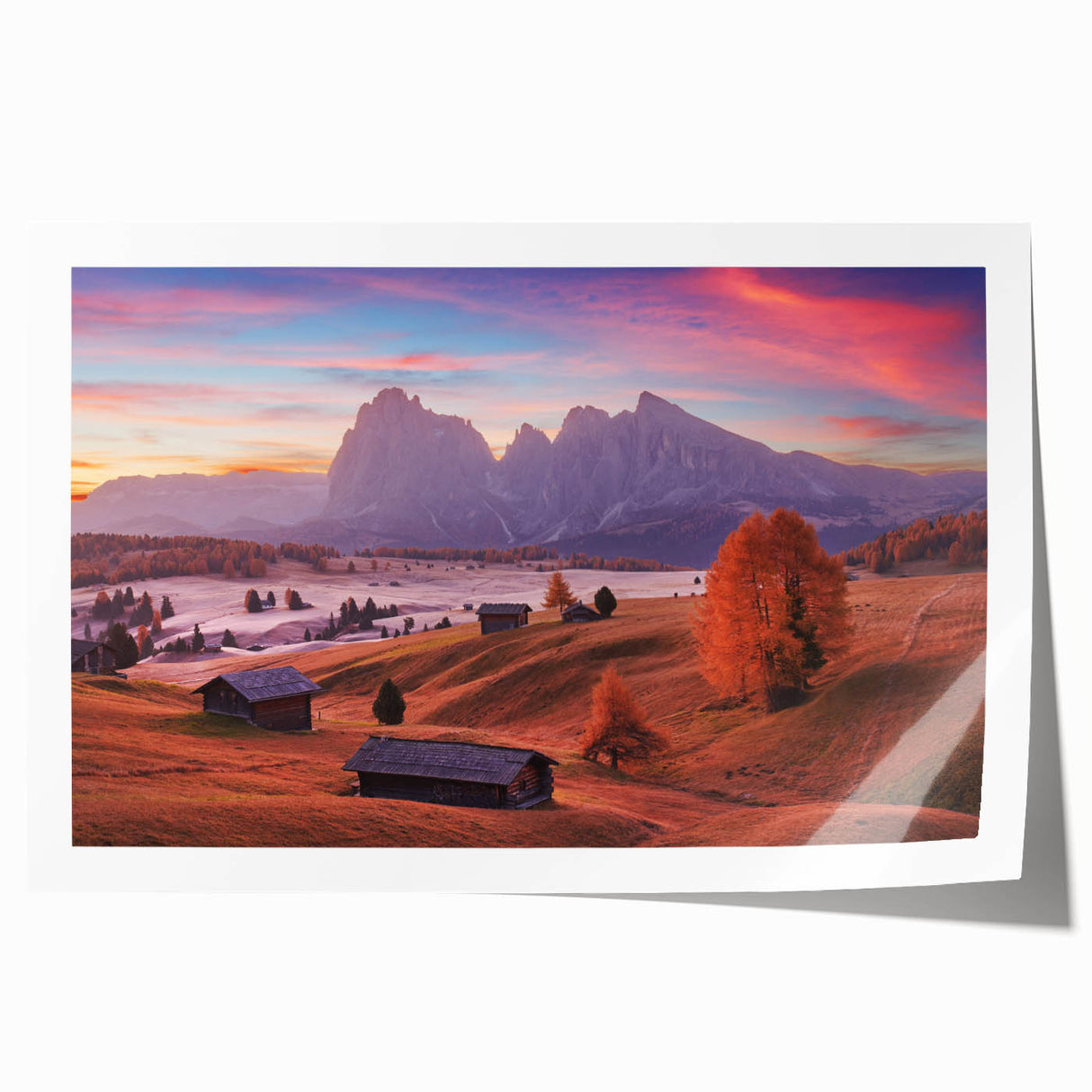 Rolled print of the Dolomites in Italy, featuring vibrant green landscapes and mountain peaks.