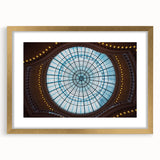 Abstract art print of Amsterdam with muted gold and blue tones on a framed canvas, suitable for dining room decor.