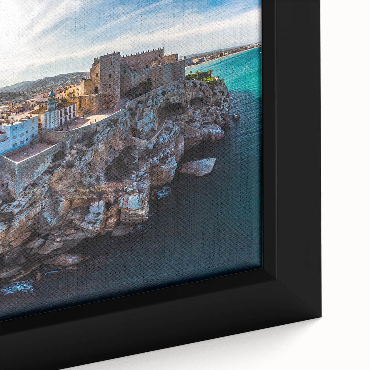 Close-up of black wall art depicting a textured, colorful European cityscape on a framed canvas, ideal for living room decor.