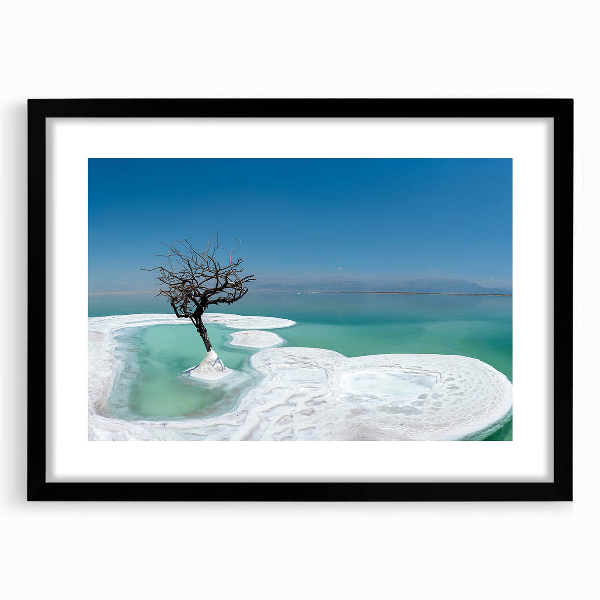 Extra large abstract art print depicting the Dead Sea in vibrant colors on a textured canvas, framed in black.