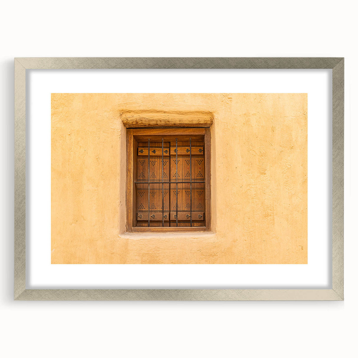 Textured art print depicting abstract scenery in muted earth tones, framed in silver, ideal for bedroom art.