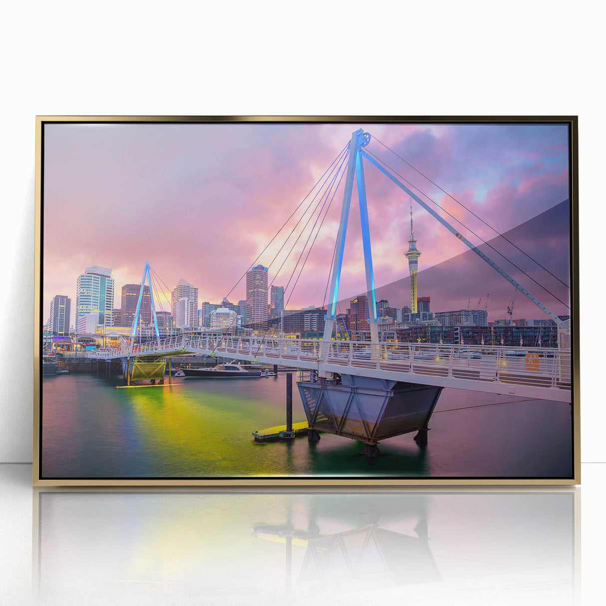 Acrylic print of Auckland skyline in muted gold and blue hues, framed in gold, ideal for modern art wall decor.