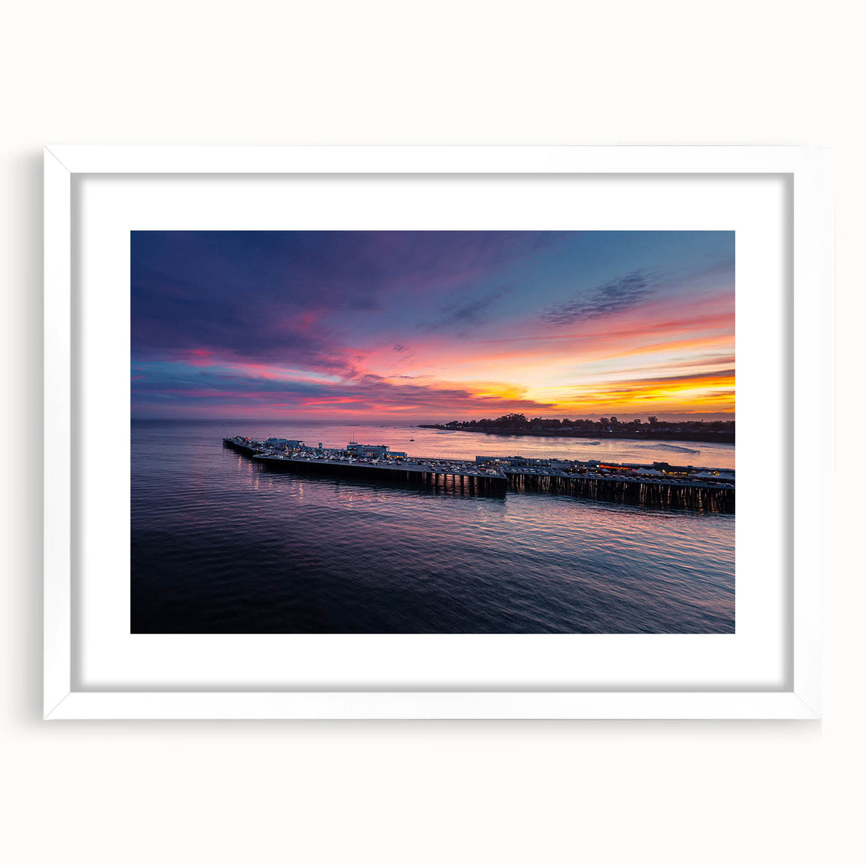 Abstract art print of Santa Cruz scenery in muted blue and green tones on a framed white mat, ideal for dining room decor.