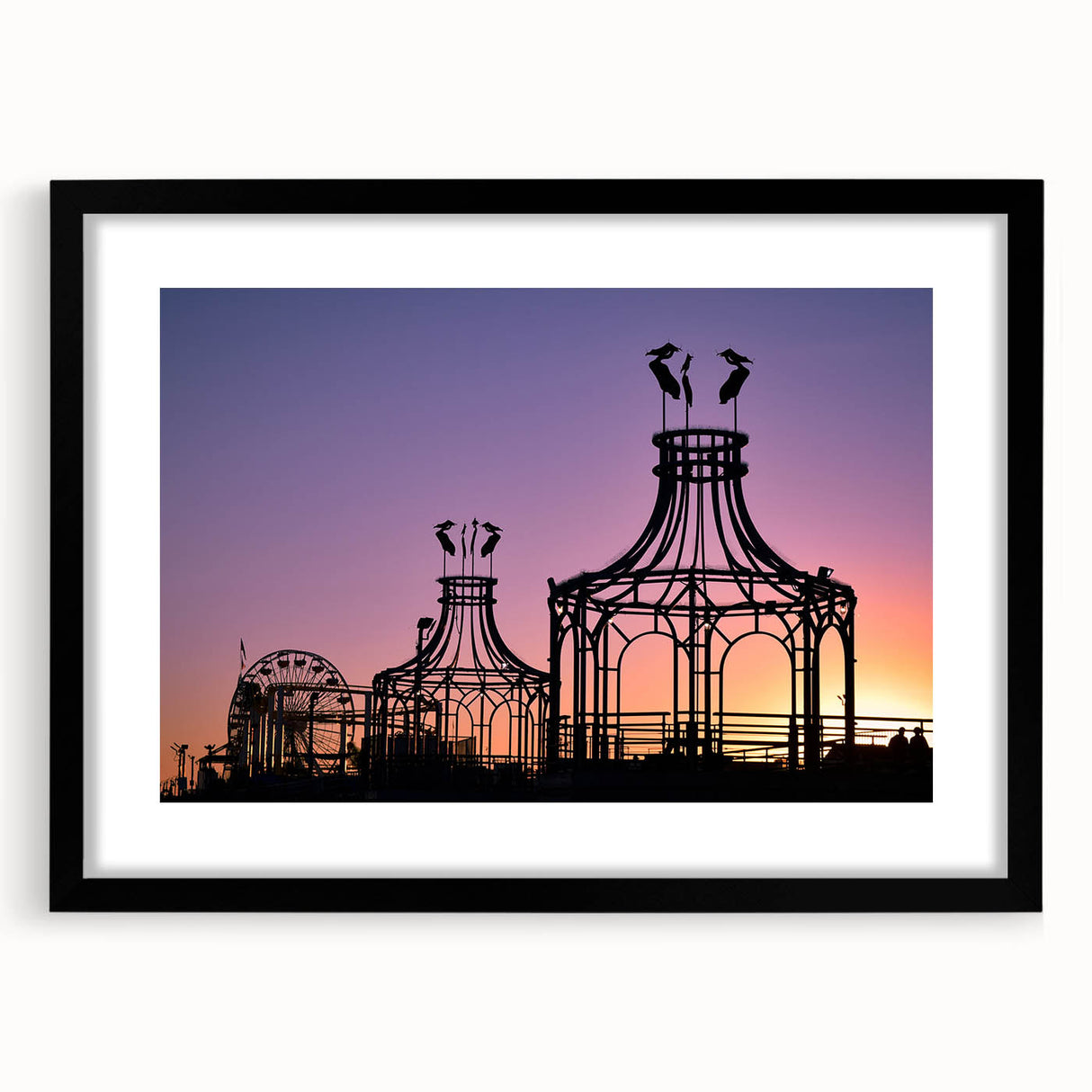 Colorful abstract art print of Santa Monica scenery in vibrant hues, framed in black, ideal for living room decor.