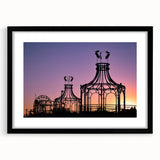 Colorful abstract art print of Santa Monica scenery in vibrant hues, framed in black, ideal for living room decor.