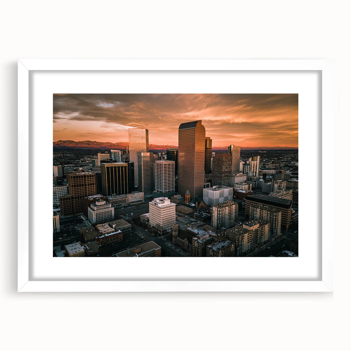 Abstract art print depicting the Denver skyline in muted gray and blue tones, framed with a white mat.