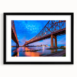 Colorful abstract art print of a textured New Orleans scene in vibrant hues, framed in black, ideal for living room decor.