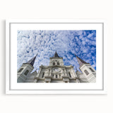 Abstract art print of St. Louis skyline in muted blue and gray tones on a framed white mat, suitable for dining room decor.