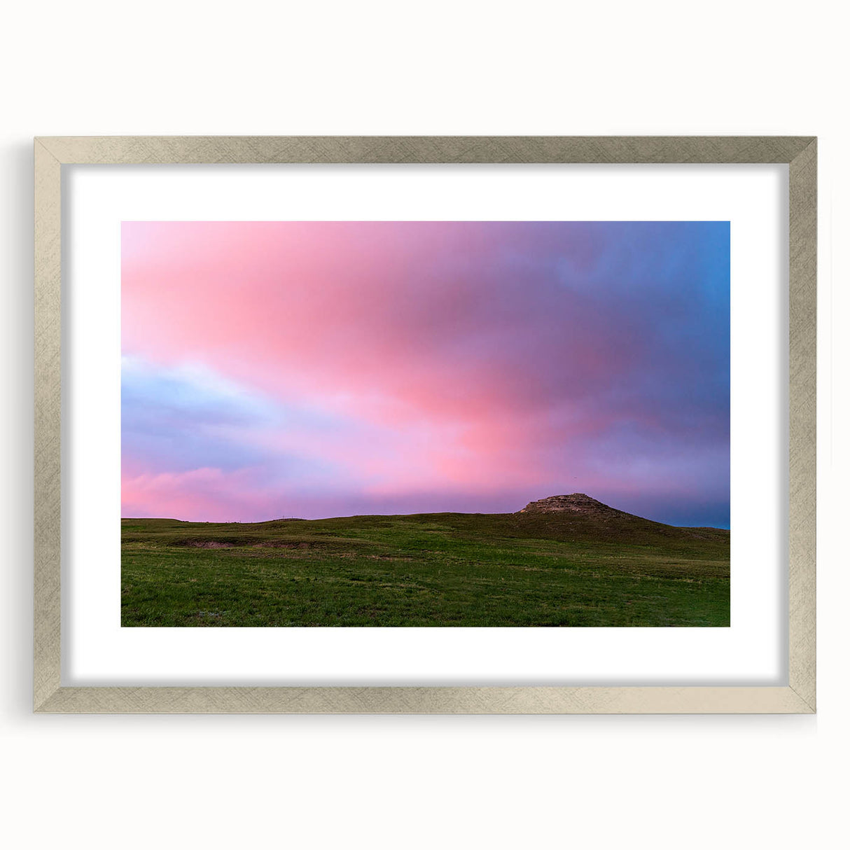 Textured art depicting abstract scenery of Nebraska in muted earth tones on a silver-framed mat, suitable for bedroom decor.