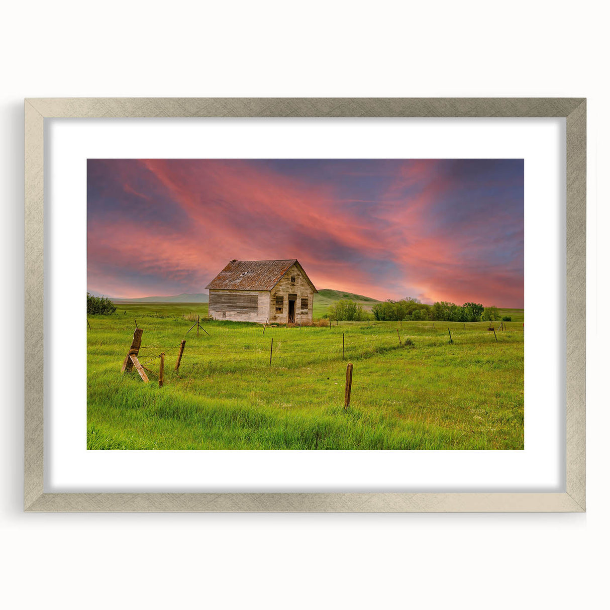 Textured abstract art print of North Dakota scenery in muted earth tones, framed in silver, suitable for bedroom decor.