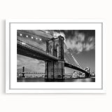 Abstract art print of the Brooklyn Bridge in muted gray and blue tones on a framed white mat.
