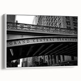 Vintage poster art of Grand Central, featuring a monochrome design with colorful accents on white framed canvas.