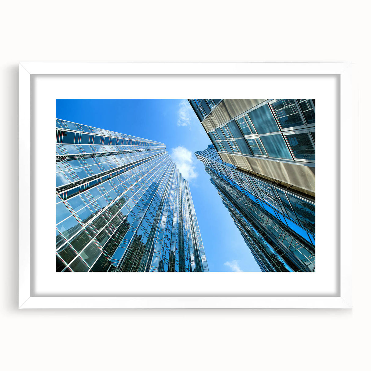 Abstract art print of Pittsburgh skyline in muted gray and blue tones, framed with a white mat, ideal for dining room decor.