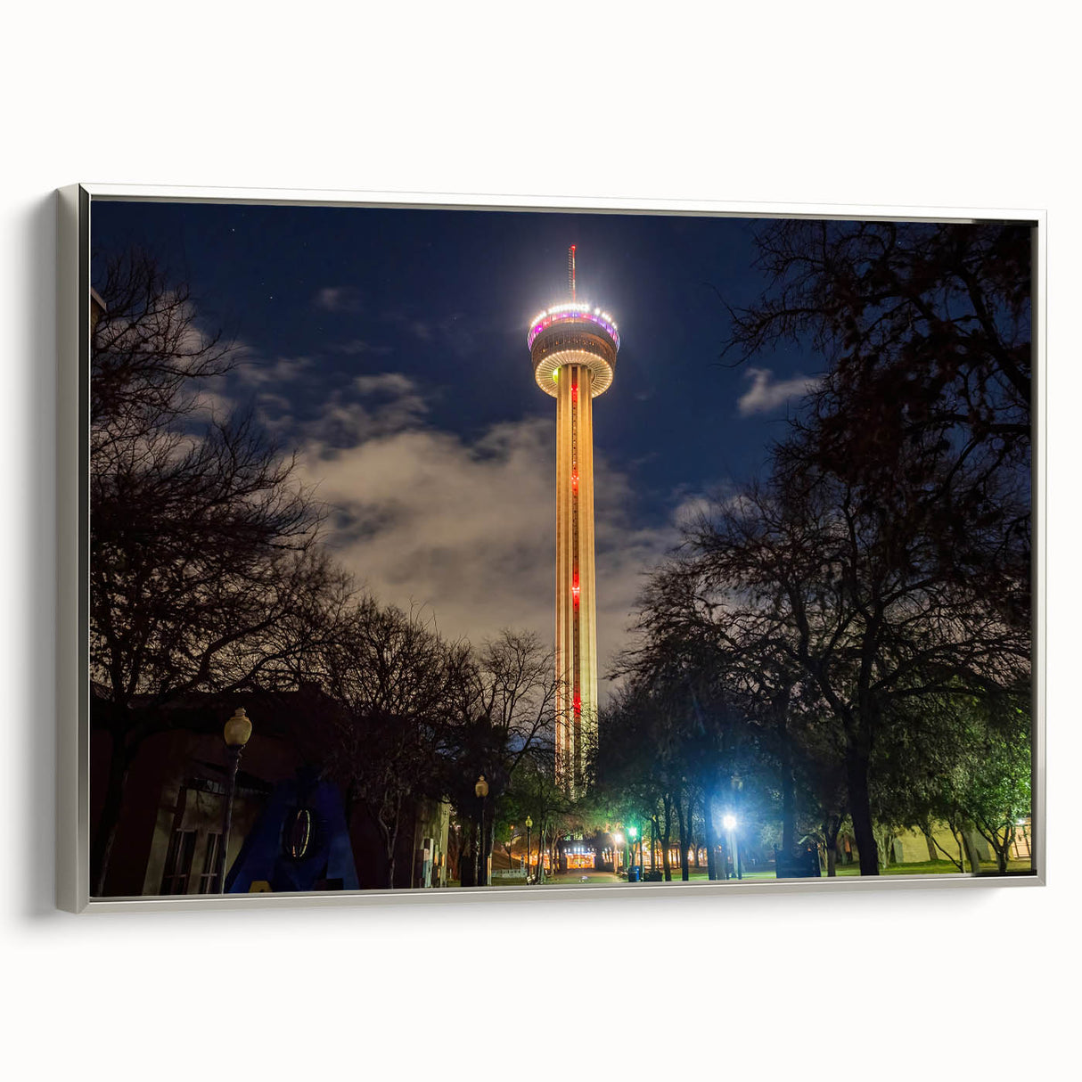 Framed canvas landscape art painting featuring the San Antonio skyline with colorful art accents on a black background.