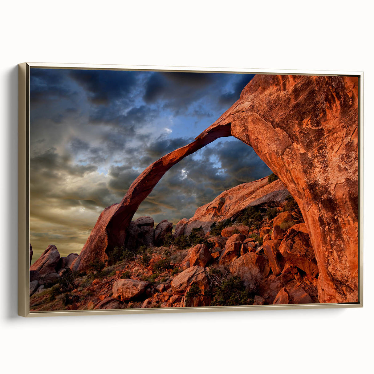Framed canvas wall art featuring a landscape painting of Arches National Park in Utah with gold frame.