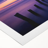 Rolled canvas artwork depicting a serene beach landscape with vibrant blue skies and golden sands, elegantly packaged in a protective cardboard tube for safe shipping.