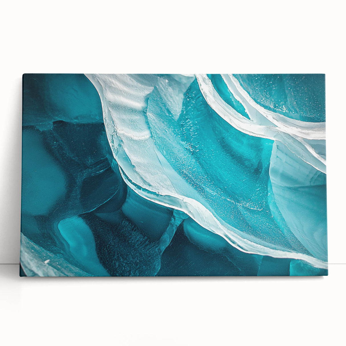 Stretched canvas artwork displaying a vibrant landscape scene with caves, featuring rich colors and intricate details, leaning against a textured wall.