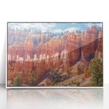 Framed acrylic artwork showcasing a vibrant landscape of canyons, featuring rich earth tones and dramatic rock formations, perfect for home decor or office ambiance.
