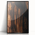 Large abstract wall art with vibrant orange and yellow tones on acrylic, framed in black, ideal for modern living room decor.