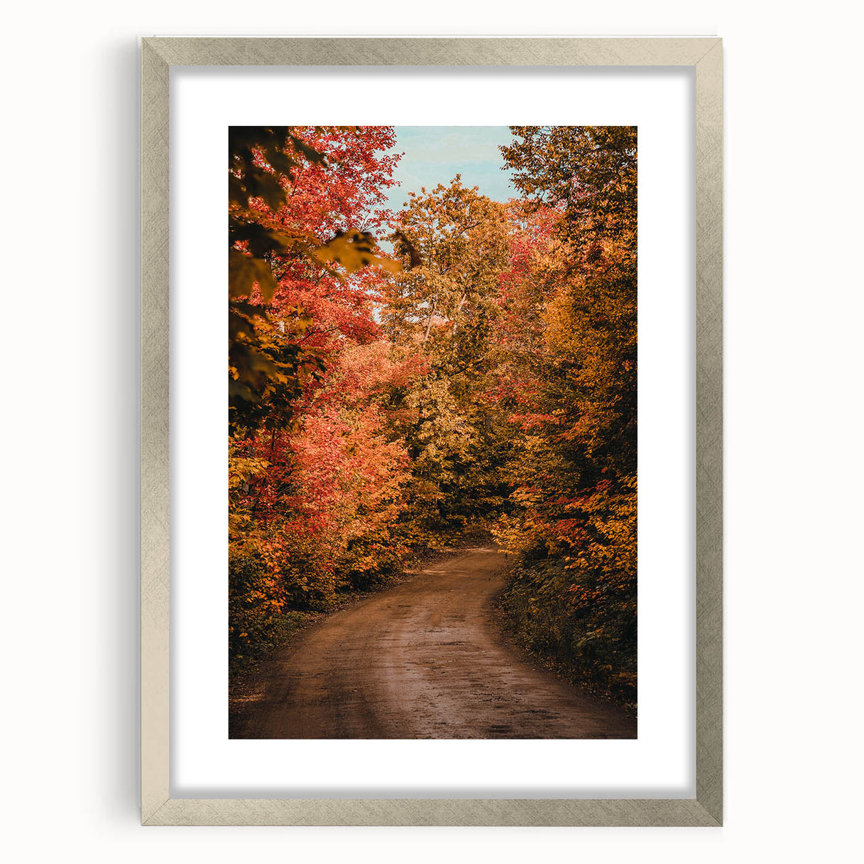Textured abstract art print in warm autumnal tones on a silver-framed canvas, ideal for bedroom wall decor.