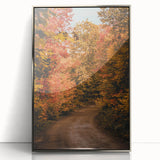 Mid-century modernist art depicting an abstract fall landscape in warm orange and brown tones, framed in silver acrylic.