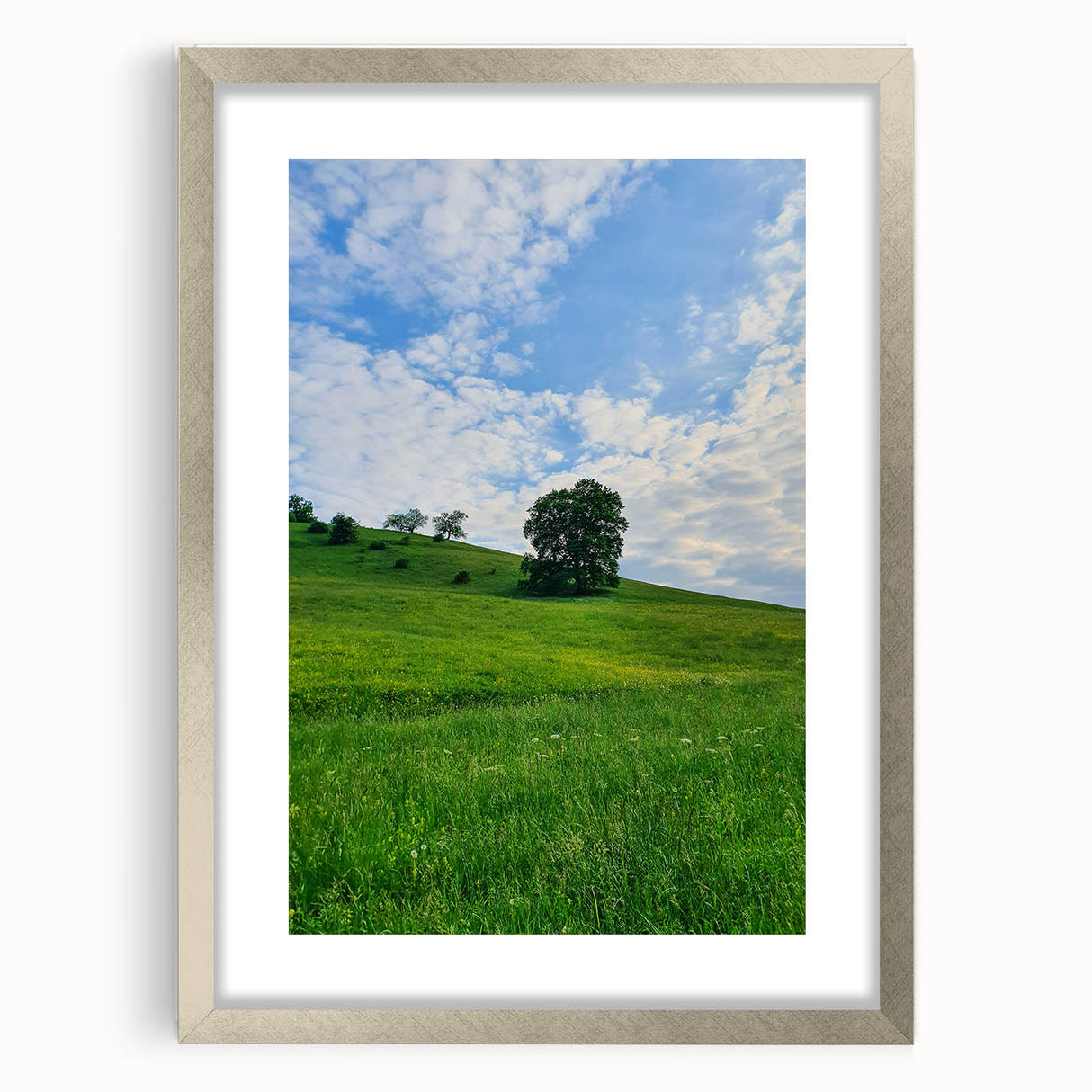 Textured abstract art print in soft green and white tones on a silver-framed canvas, suitable for bedroom decor.