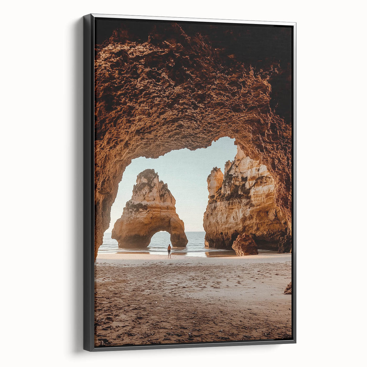 Framed canvas artwork showcasing a stunning landscape with intricate cave formations, featuring a sleek black frame and side view display, perfect for home decor.