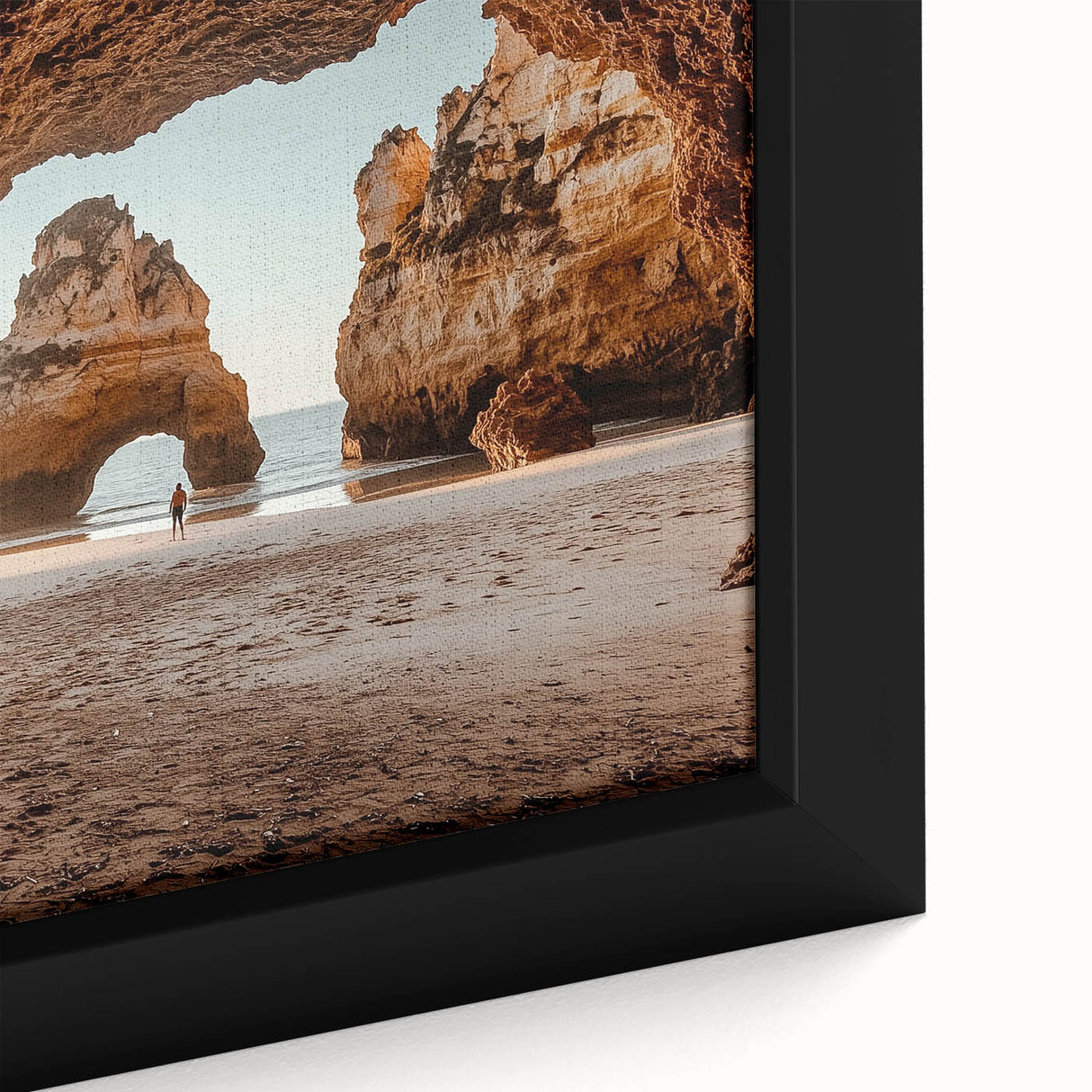Close-up of a framed canvas artwork depicting a vibrant landscape with caves, showcasing intricate details and earthy tones, perfect for home decor.