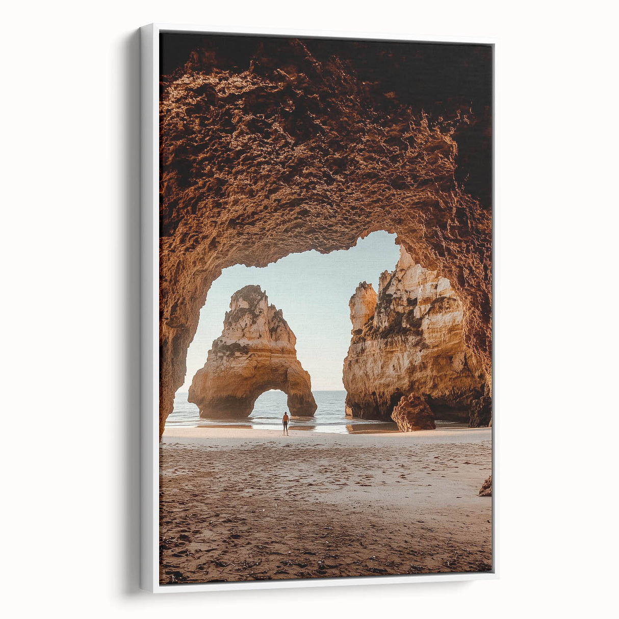 Framed canvas artwork depicting a serene landscape with caves, showcased from a side view against a white background, perfect for home decor.