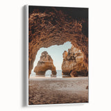 Framed canvas artwork depicting a serene landscape with caves, showcased from a side view against a white background, perfect for home decor.
