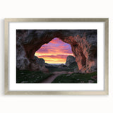 Framed landscape artwork depicting a serene cave scene, featuring a silver mat border and elegant frame, ideal for home decor in modern settings.
